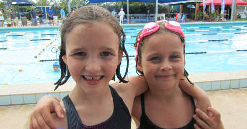 SWIM HAPPY: Emerald Little Seals swimmers Eleanor and Chontelle Sands at the Moranbah carnival. cont SWIM HAPPY: Emerald Little Seals swimmers Eleanor and Chontelle Sands at the Moranbah carnival. cont